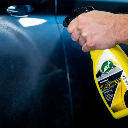 Applying Turtle Wax waterless wash. Car detailing spray for a streak-free finish.
