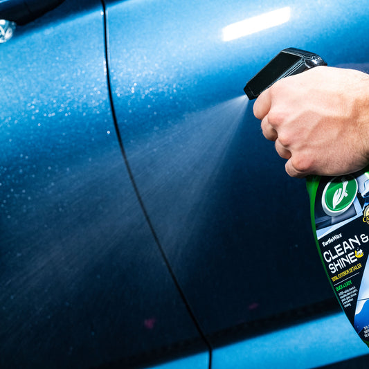 Turtle Wax detailer being sprayed on a car panel. Quick car care for exterior paint, glass, and chrome detailing.