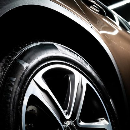 Car wheel detail: 235/60R18 tyre with high-gloss finish, paired with a modern alloy wheel on a luxury vehicle.
