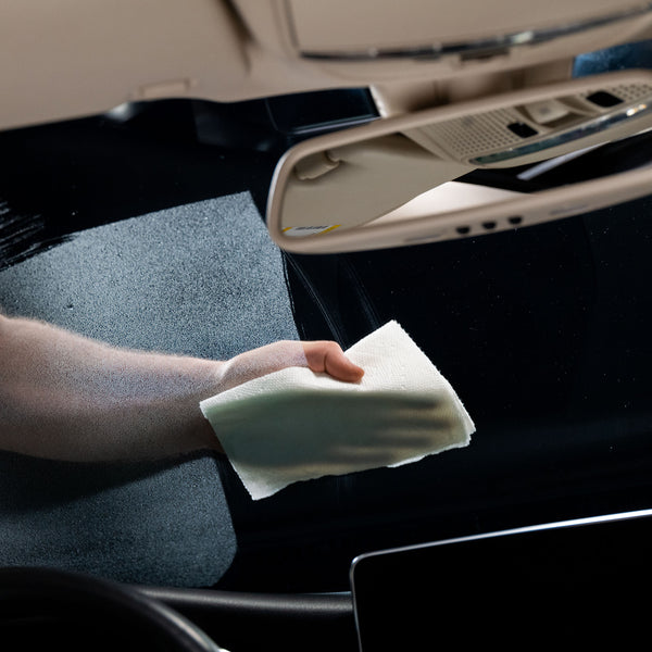 Photograph of a dual-sided cleaning mitt, with one side featuring microfiber strands and the other a mesh surface, designed for versatile car cleaning tasks.