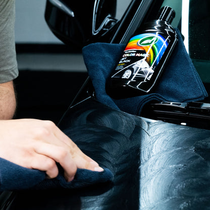 Turtle Wax Color Magic Black car wax 500ml being applied with a microfibre cloth to a black car. Car detailing.