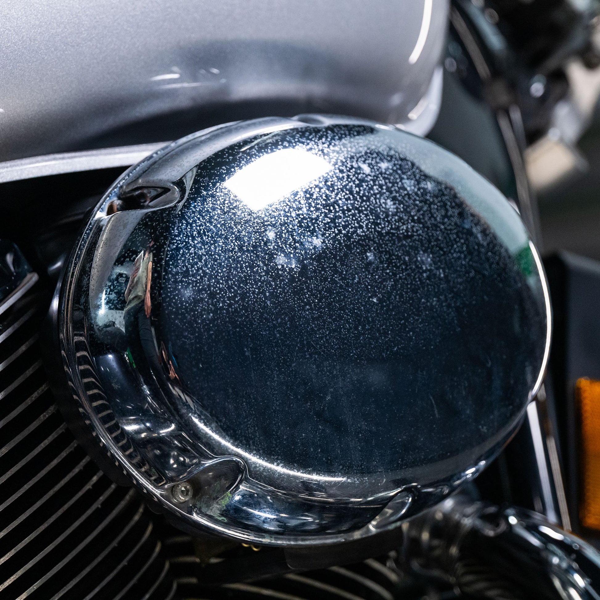 Dirty chrome headlight casing on motorcycle needs polishing. Perfect job for Turtle Wax.
