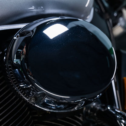 Chrome motorcycle part with reflection. Metal care product may help keep it sparkling.