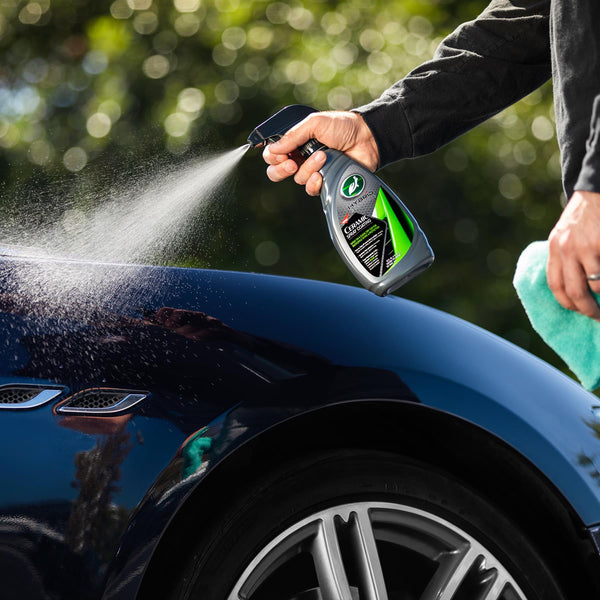 Angled image of HS Ceramic Spray bottle with a trigger sprayer, set against a dark background, emphasizing the sleek, modern design of the product.