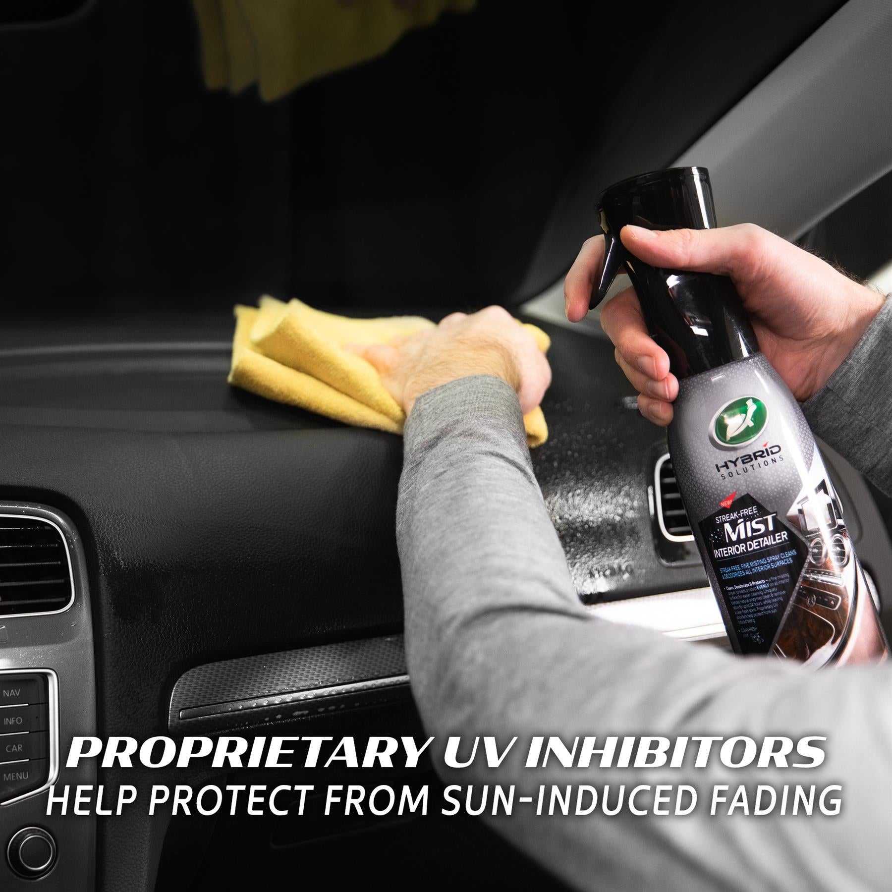 Turtle Wax Hybrid Solutions Mist. Detailer cleans a car interior's dashboard with a cloth. Streak-free.